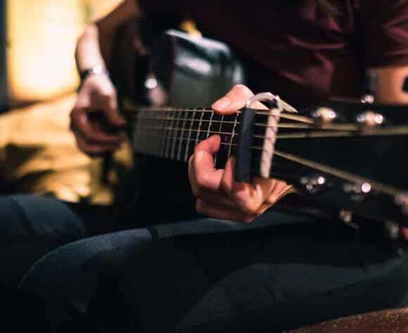 Jess Loh playing guitar. Photo by Carina Sze.